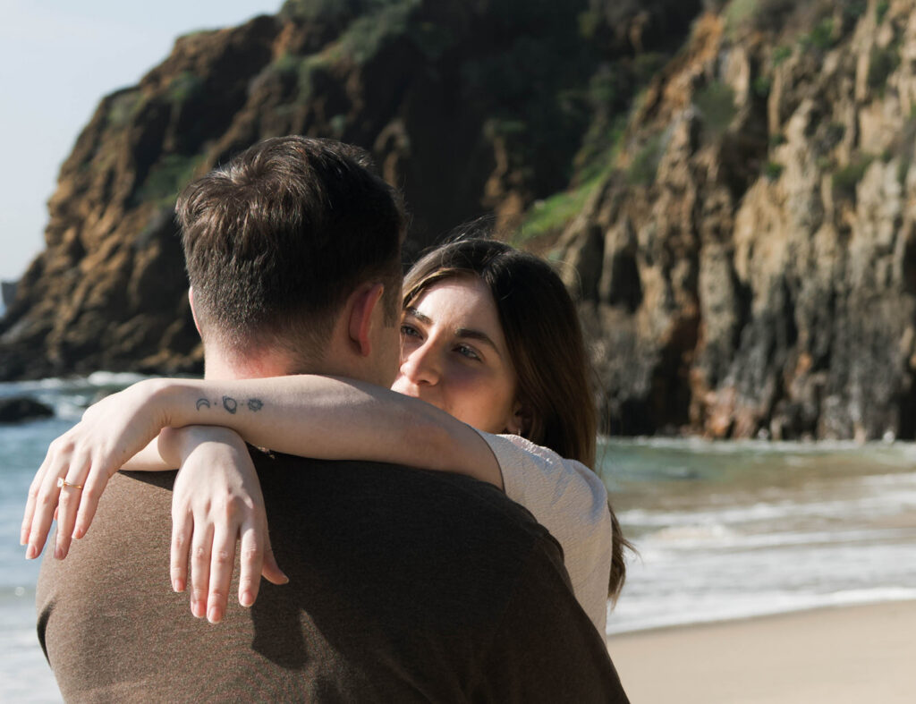 Cinematic film inspired engagement photos in Laguna Beach with Arizona couple in neutral outfits