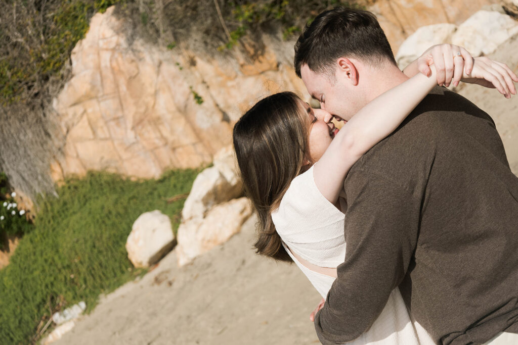 Cinematic film inspired engagement photos in Laguna Beach with Arizona couple in neutral outfits