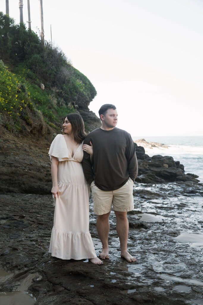 Cinematic film inspired engagement photos in Laguna Beach with Arizona couple in neutral outfits