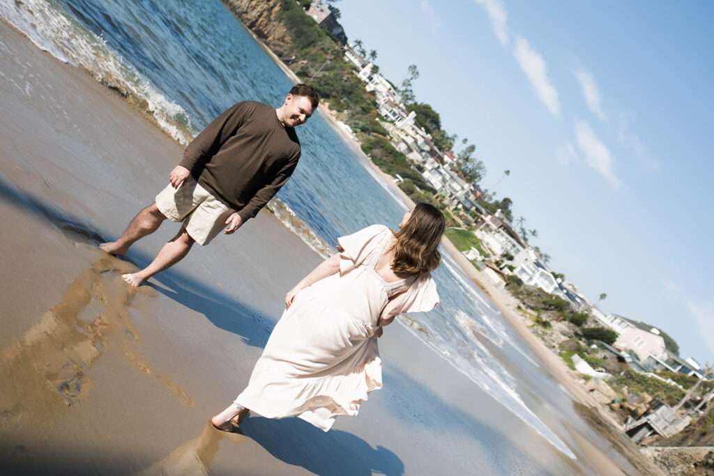 Cinematic film inspired engagement photos in Laguna Beach with Arizona couple in neutral outfits