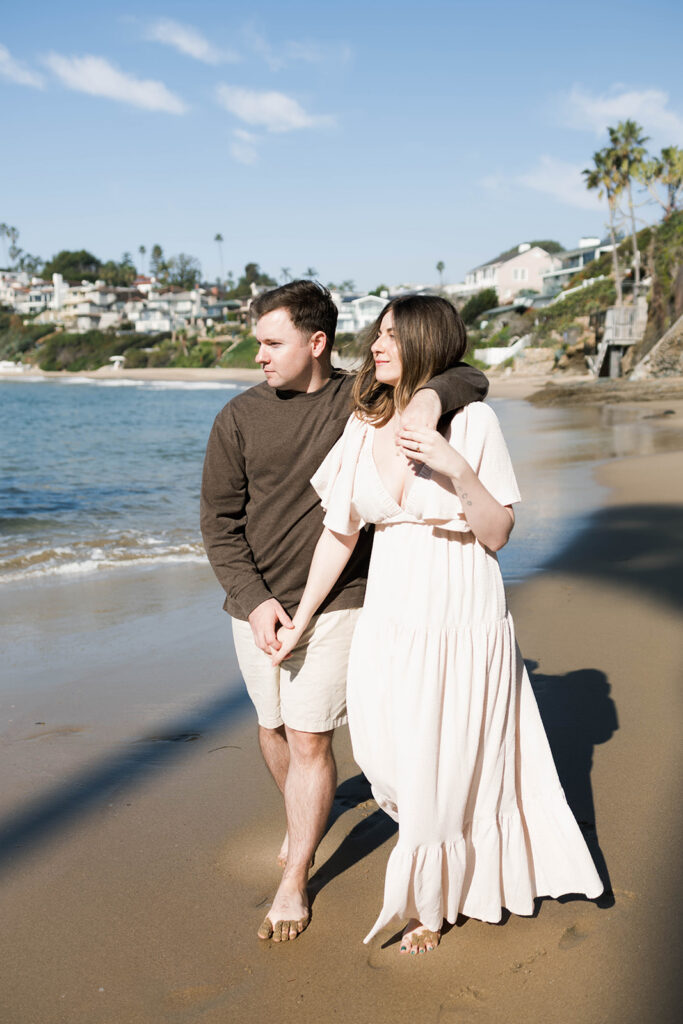 Cinematic film inspired engagement photos in Laguna Beach with Arizona couple in neutral outfits