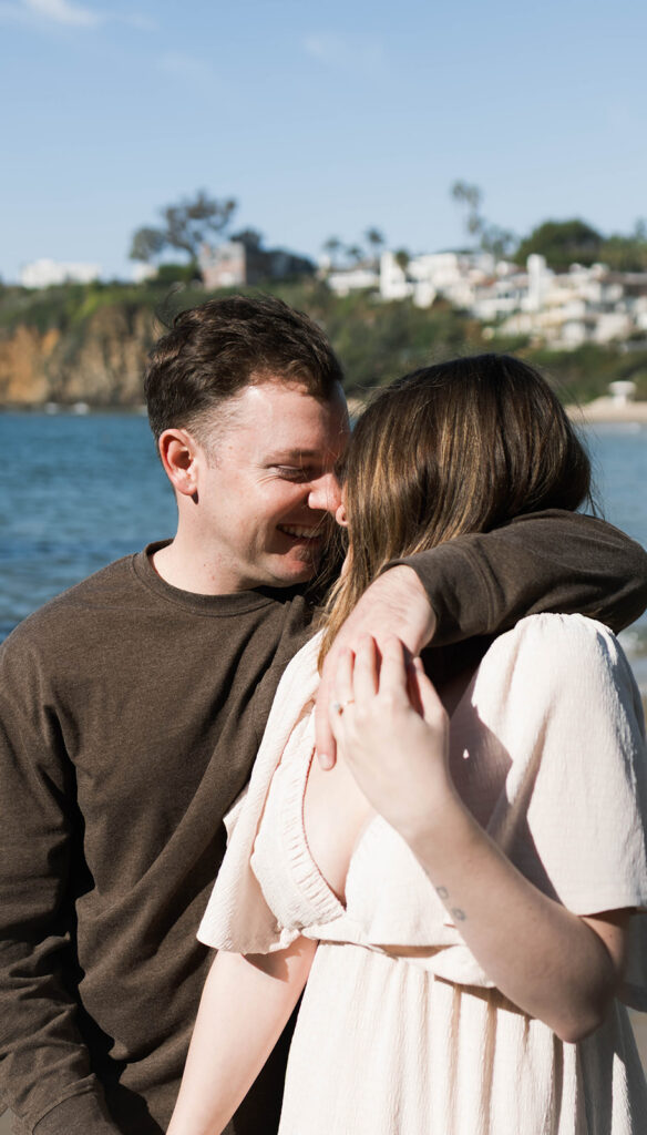 Cinematic film inspired engagement photos in Laguna Beach with Arizona couple in neutral outfits