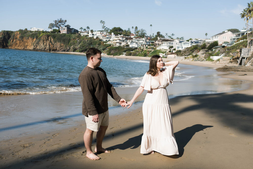 Cinematic film inspired engagement photos in Laguna Beach with Arizona couple in neutral outfits