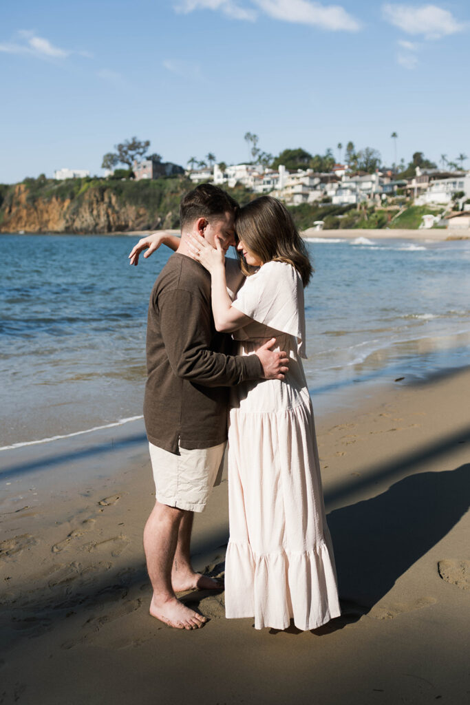 Cinematic film inspired engagement photos in Laguna Beach with Arizona couple in neutral outfits