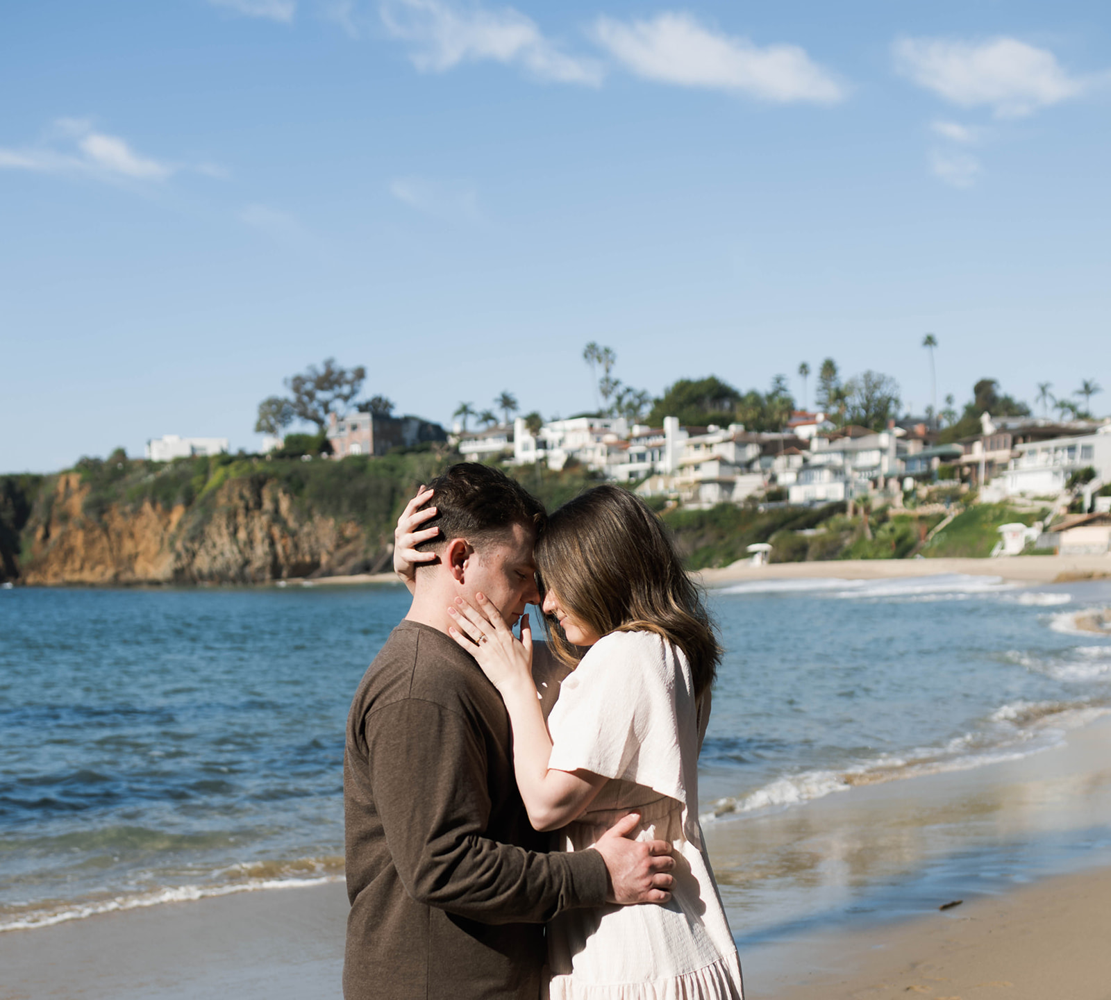 Cinematic film inspired engagement photos in Laguna Beach with Arizona couple in neutral outfits