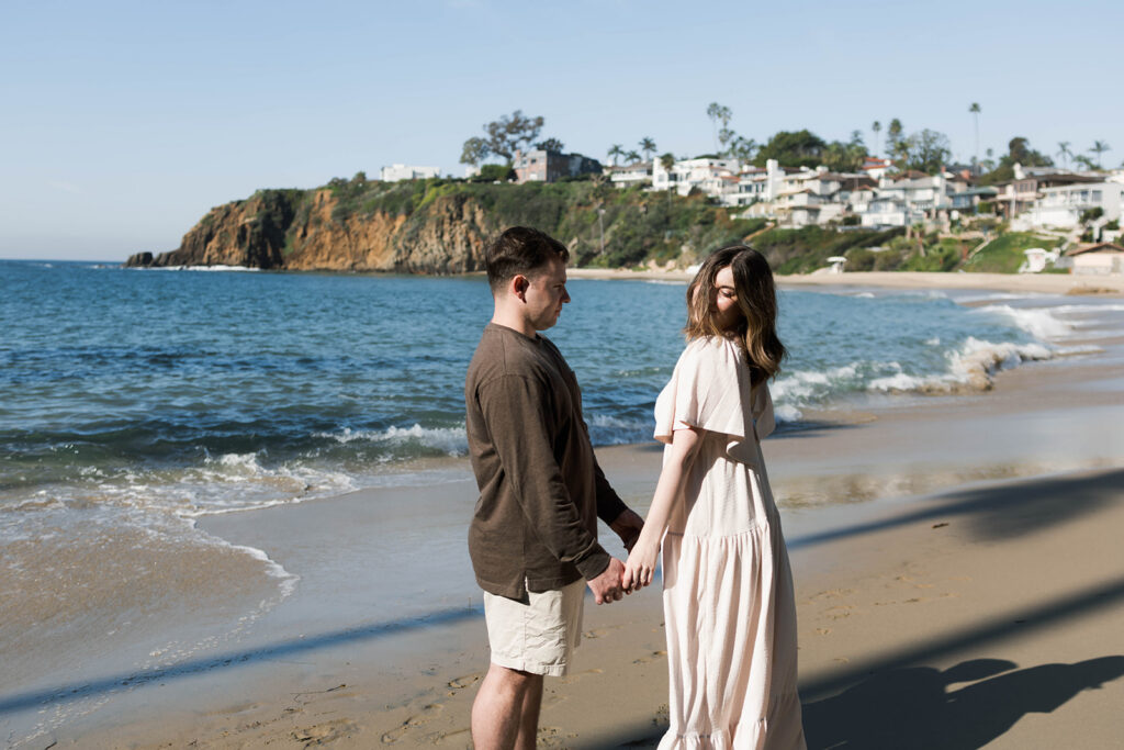 Cinematic film inspired engagement photos in Laguna Beach with Arizona couple in neutral outfits