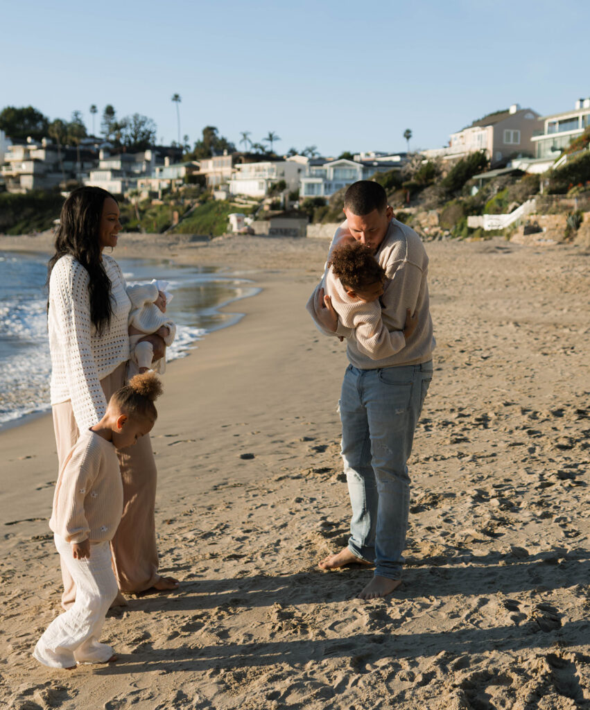 family photoshoot on the beach at sunset