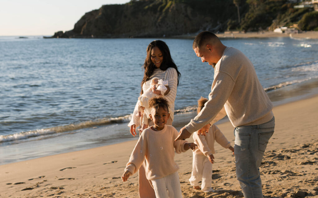 family photoshoot on the beach at sunset