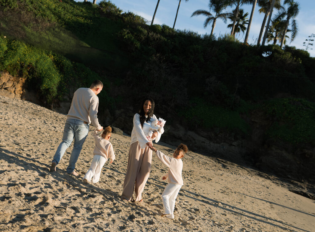 family photoshoot on the beach at sunset