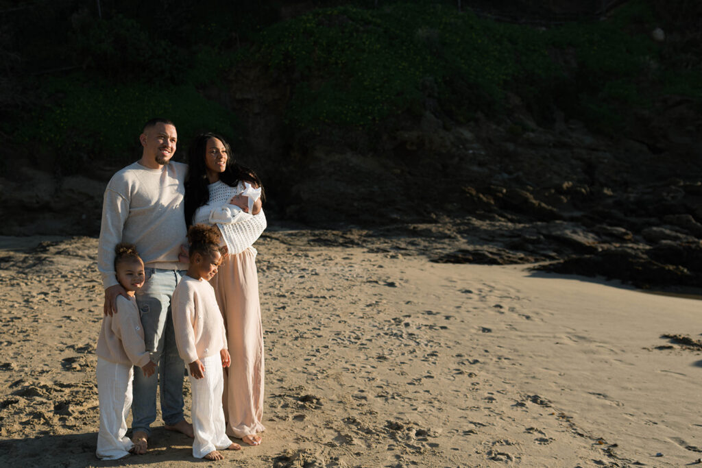 family photoshoot on the beach at sunset
