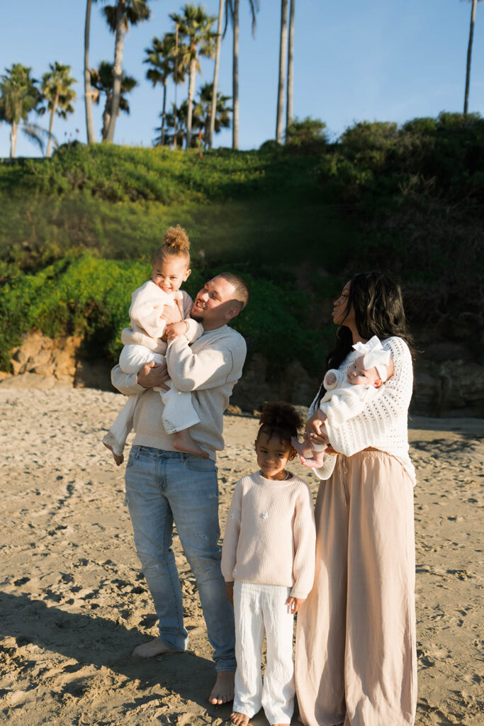 family photoshoot on the beach at sunset