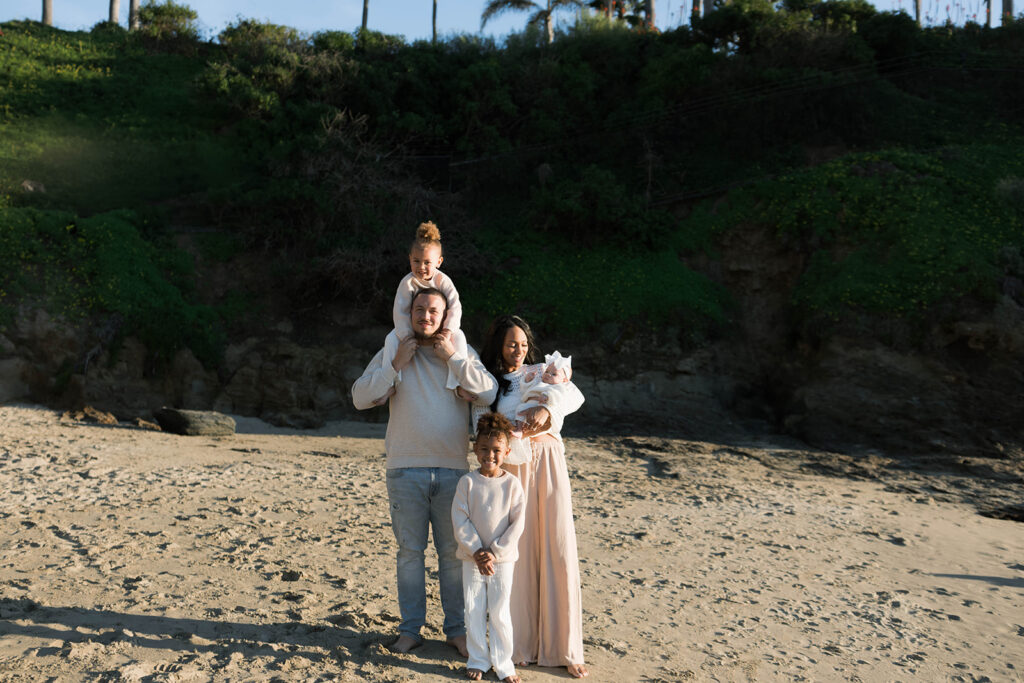 family photoshoot on the beach at sunset