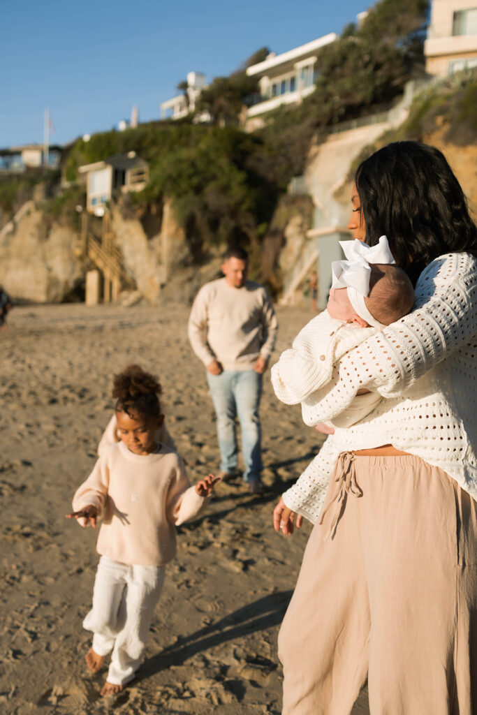 family photoshoot on the beach at sunset