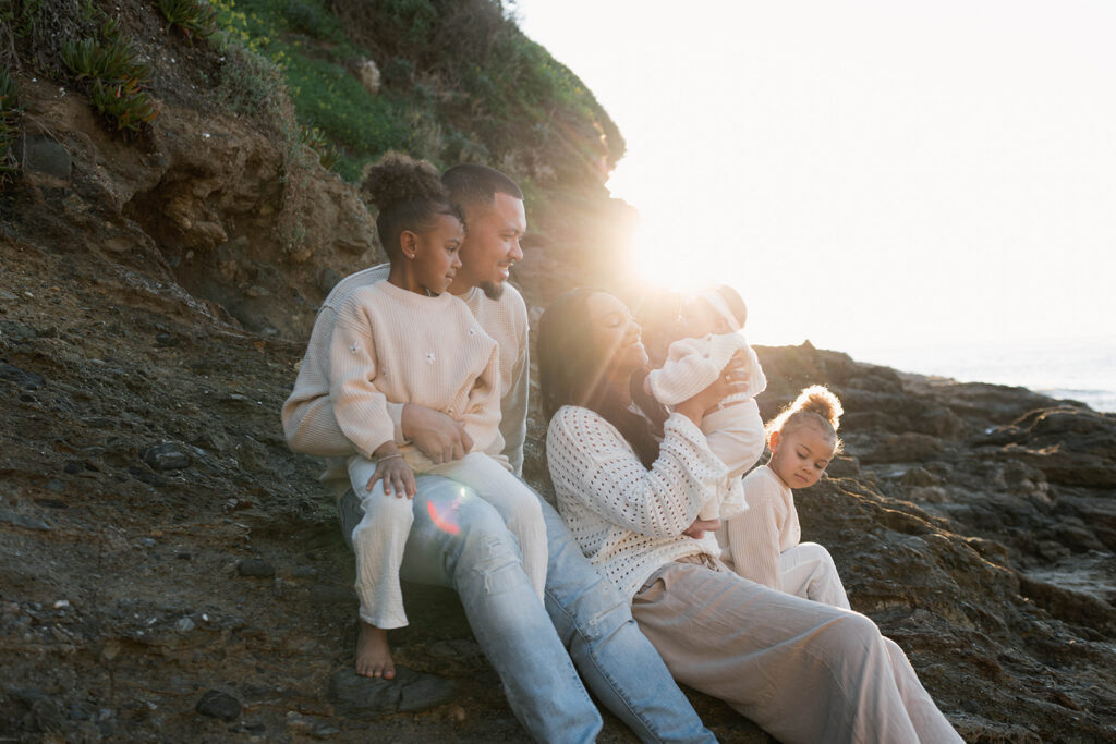 family photoshoot on the beach at sunset