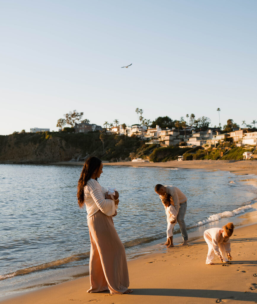 family photoshoot on the beach at sunset