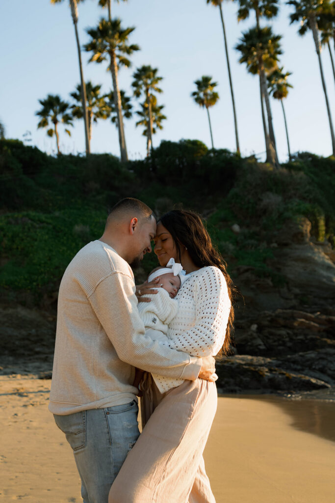 family photoshoot on the beach at sunset