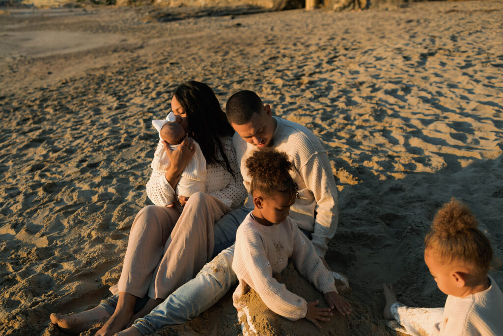 family photoshoot on the beach at sunset