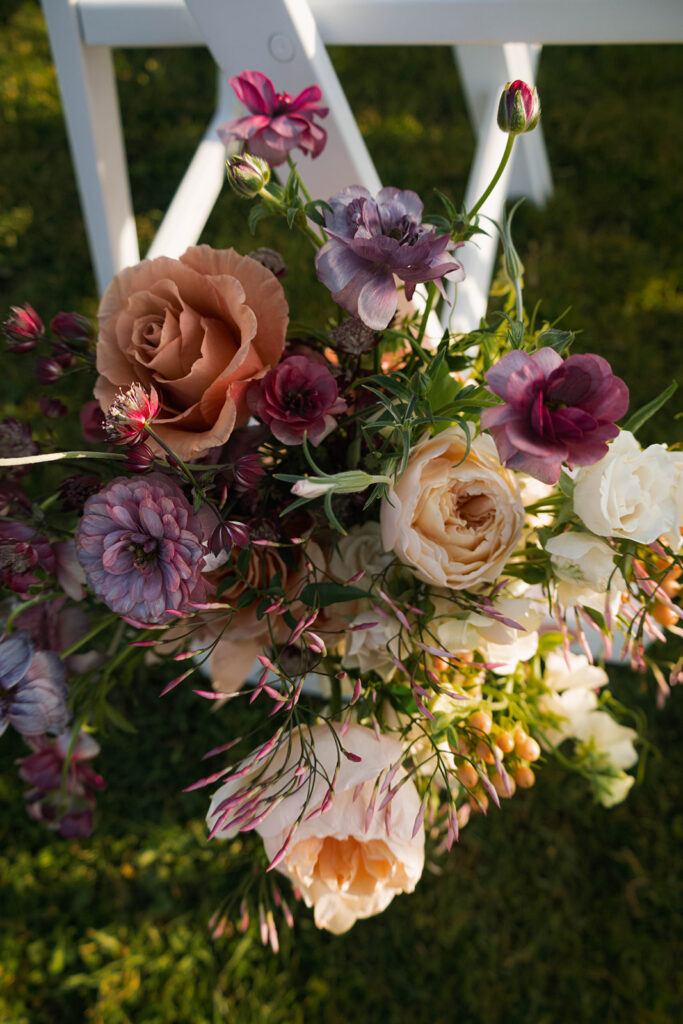 Intimate beach elopement ceremony with family gathered on a cliffside
