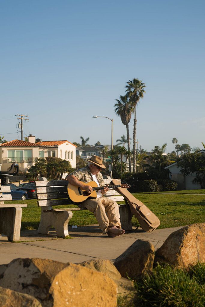Intimate beach elopement ceremony with family gathered on a cliffside