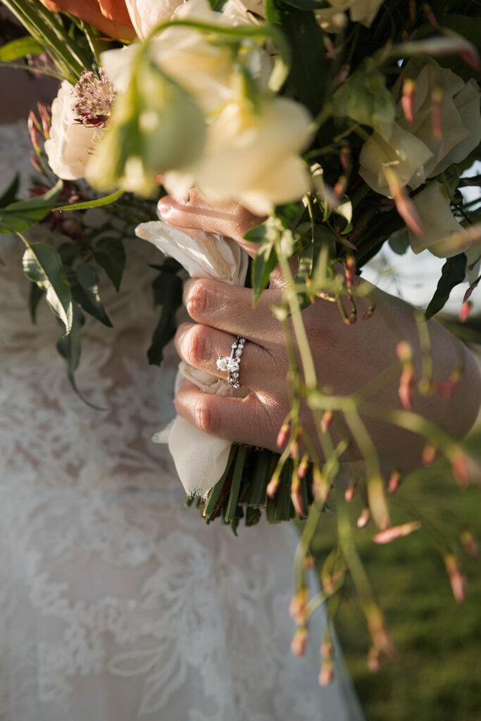 Intimate beach elopement ceremony with family gathered on a cliffside