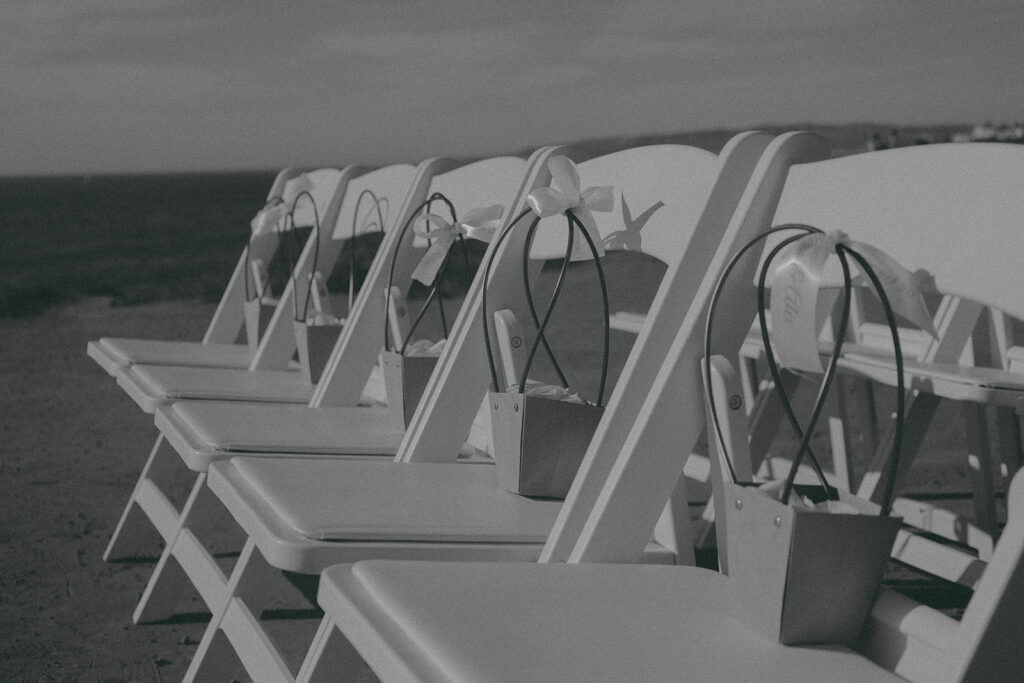 Intimate cliffside elopement ceremony overlooking the ocean at sunset