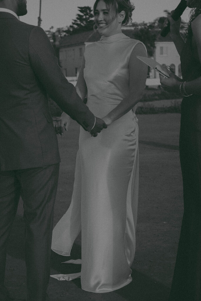 Intimate cliffside elopement ceremony overlooking the ocean at sunset