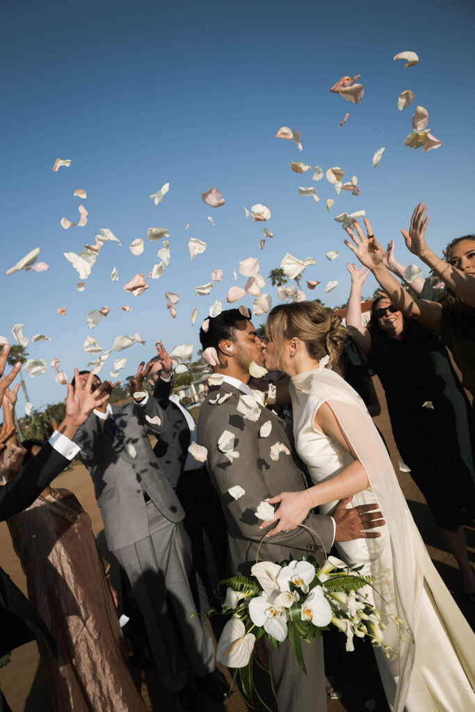 Intimate cliffside elopement ceremony overlooking the ocean at sunset