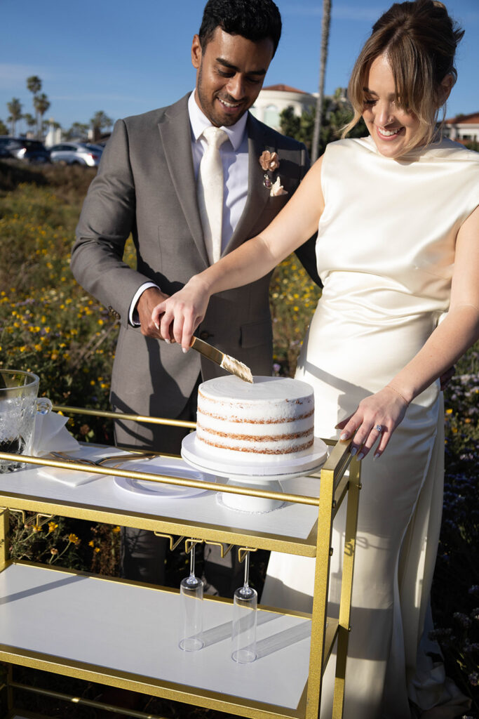 Intimate cliffside elopement ceremony overlooking the ocean at sunset
