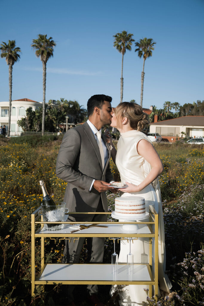Intimate cliffside elopement ceremony overlooking the ocean at sunset