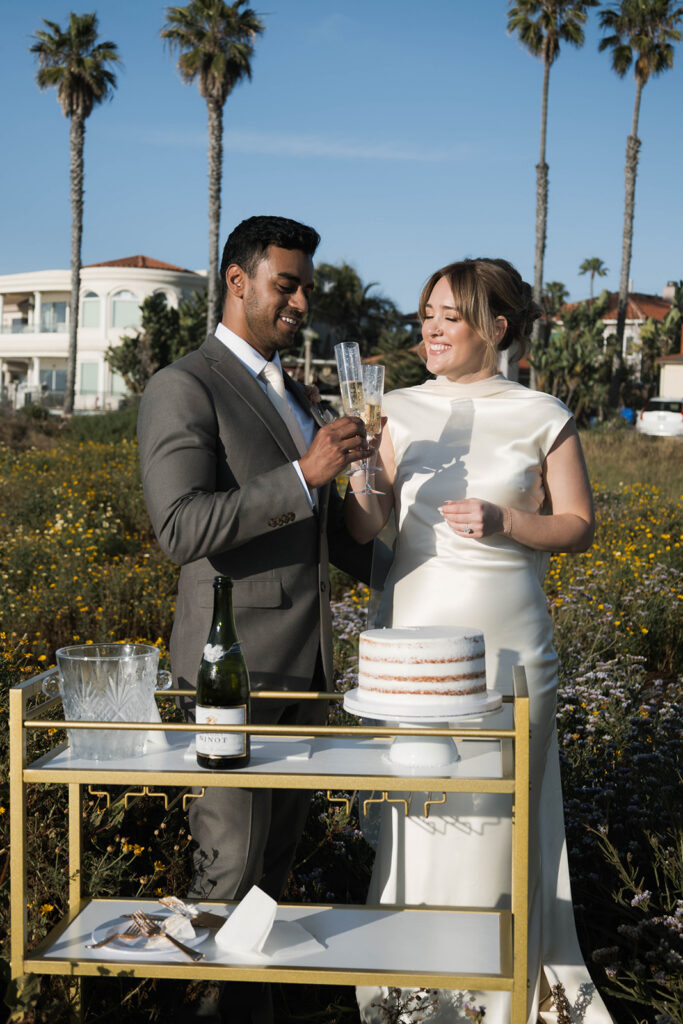 Intimate cliffside elopement ceremony overlooking the ocean at sunset