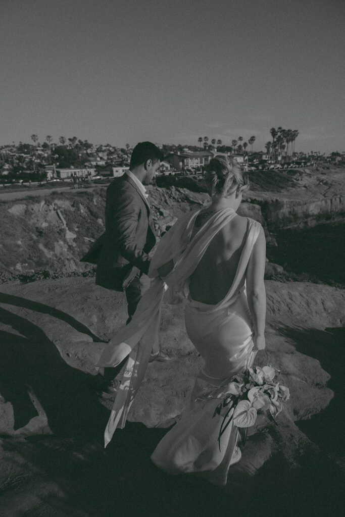 Intimate cliffside elopement ceremony overlooking the ocean at sunset