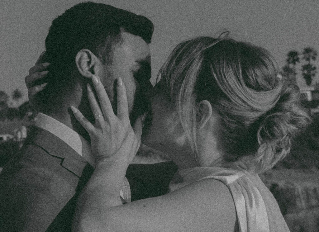 Intimate cliffside elopement ceremony overlooking the ocean at sunset