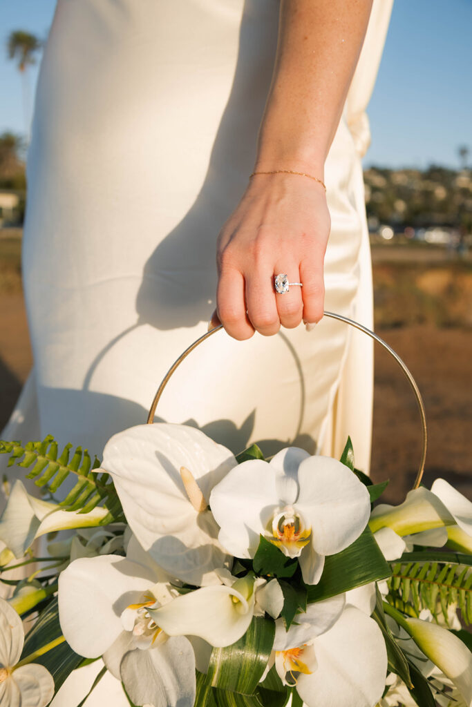 Intimate cliffside elopement ceremony overlooking the ocean at sunset