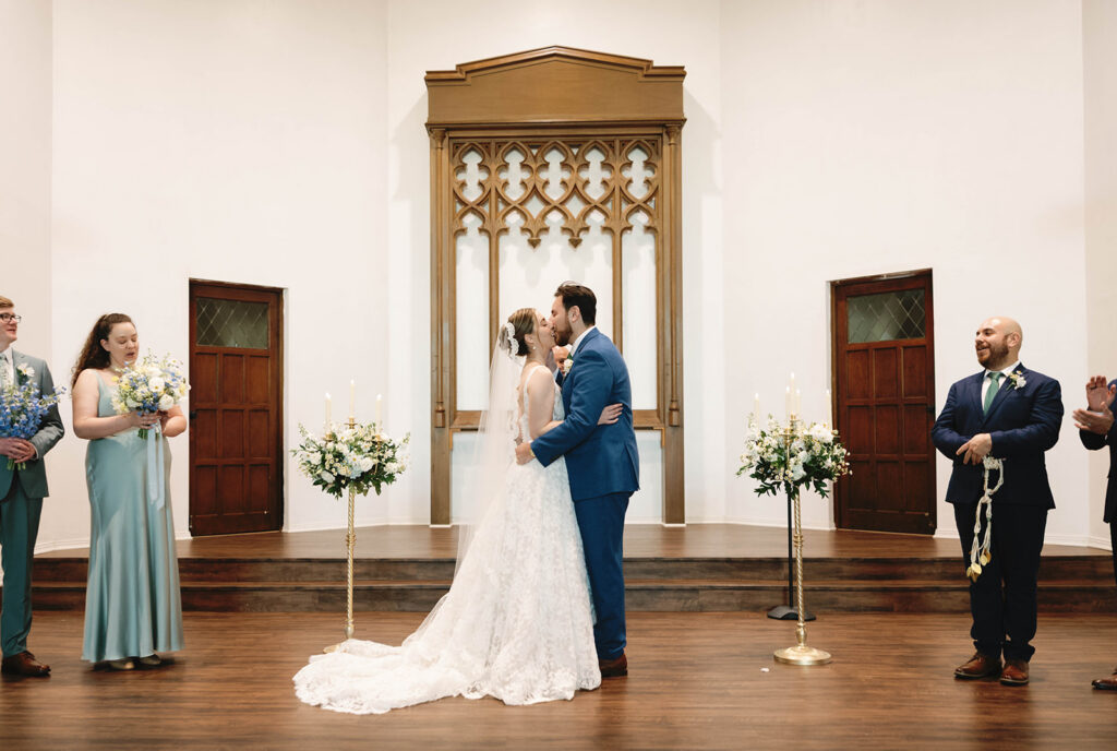 Romantic wedding scene featuring soft pastel florals, elegant decor, emotional couple moments, and guests celebrating in a light-filled venue inspired by Monet’s water lily paintings.