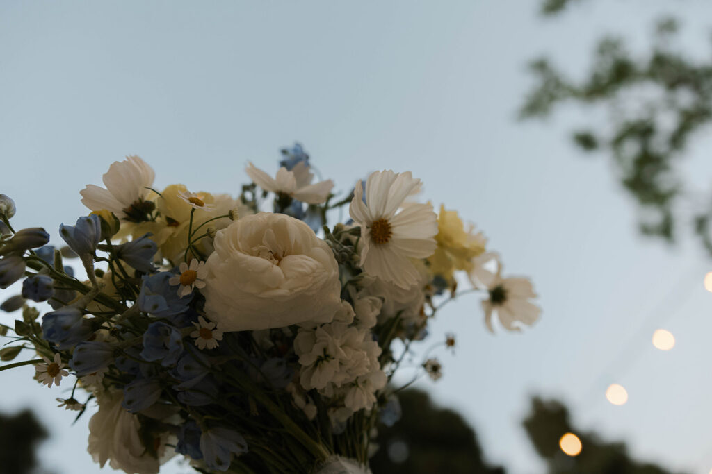 Romantic wedding scene featuring soft pastel florals, elegant decor, emotional couple moments, and guests celebrating in a light-filled venue inspired by Monet’s water lily paintings.