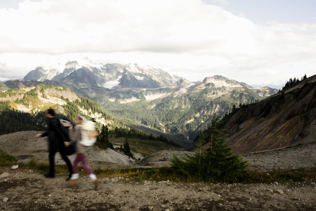 bride and groom running in the north cascades mountains of washington