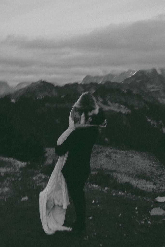 bride and groom portrait hugging and spinning in the north cascades mountains of washington